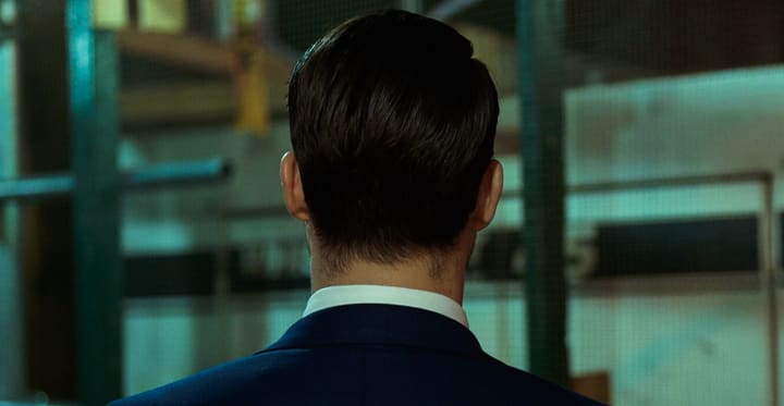 man from behind in suit, dim office