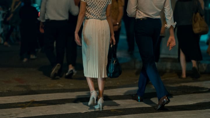 woman crossing street at night