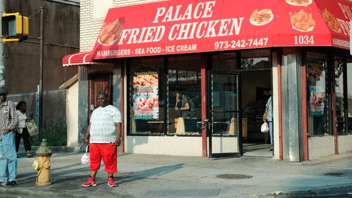 man outside fried chicken shop