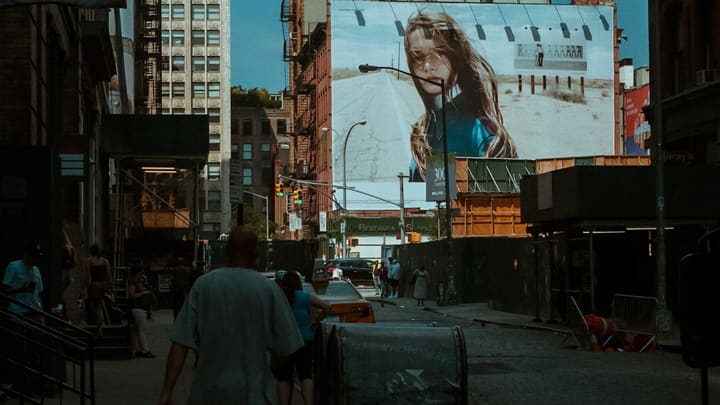 street at dusk with giant billboard