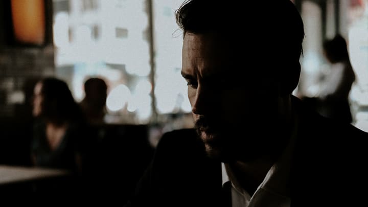 man's profile in dim bar