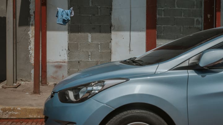 blue car parked at garage