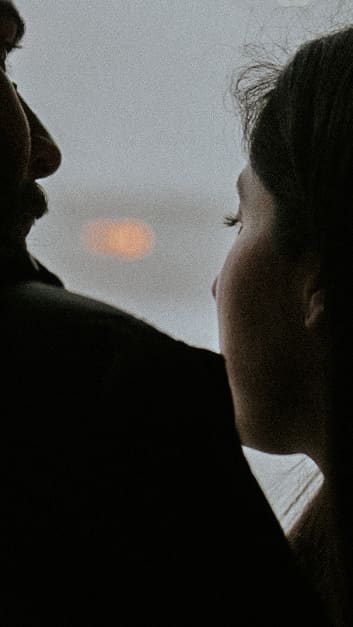 couple silhouette at window, sunset