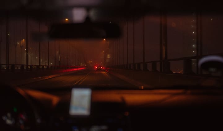 night drive across foggy bridge