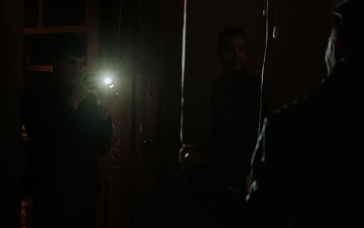 man with flashlight in dark room