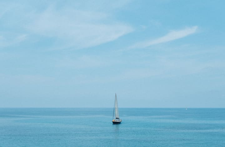 sailboat on calm blue sea