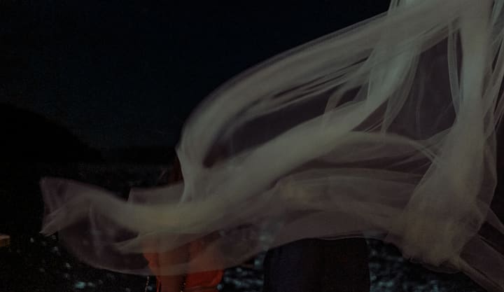 flowing white fabric at night