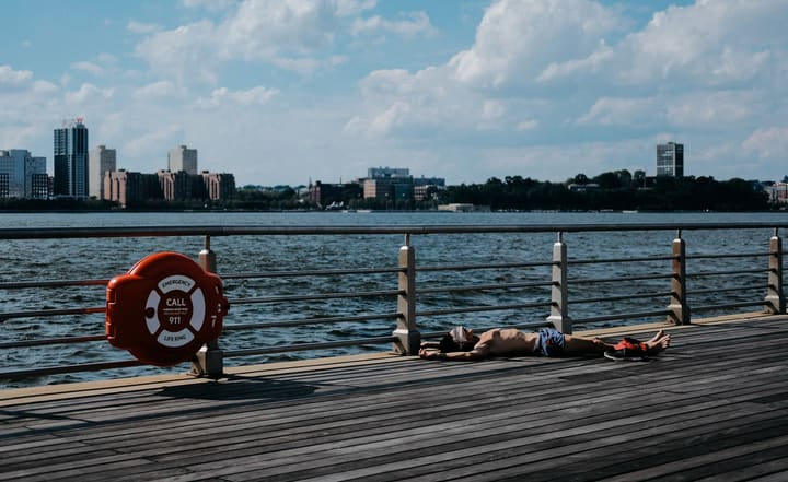 pier over harbor with city skyline