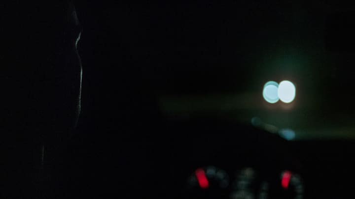 silhouette driver, blurred lights