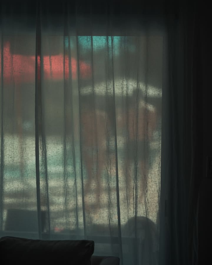 beach scene through sheer curtain